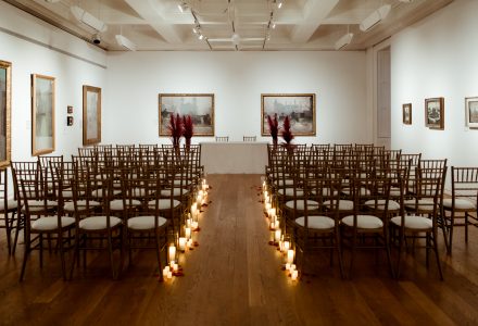 Wedding set up in gallery 16 detailing chairs and lights in the aisle