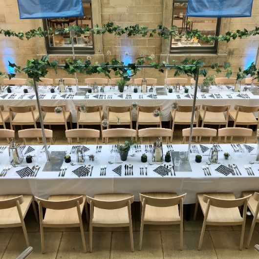 Detail of Nordic dinner table set up in the Atrium, long tables and garlands