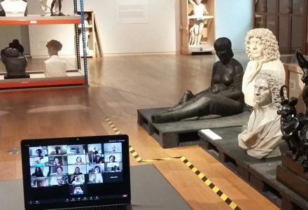 Gallery space showing sculptures and laptop with zoom session