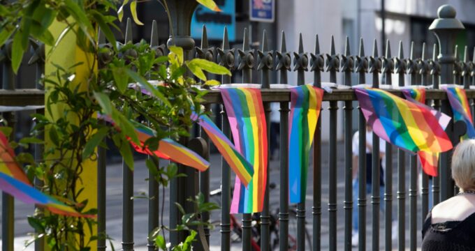 Pride flags blowing in the wind, attached to the railings of the gallery