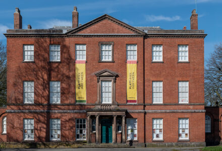 Platt Hall front victorian building with two yellow banners on each side saying, Platt hall in between